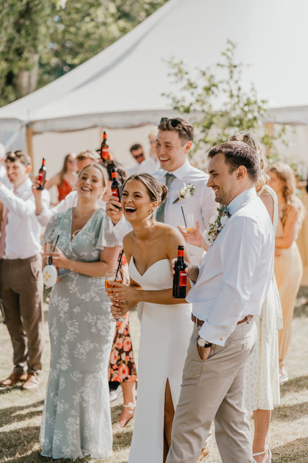 bride laughs during outdoor speeches at English Oak Vineyard wedding in dorset