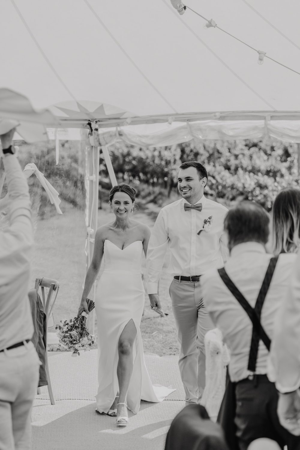 black and white photo of bride and groom entrance into wedding breakfast