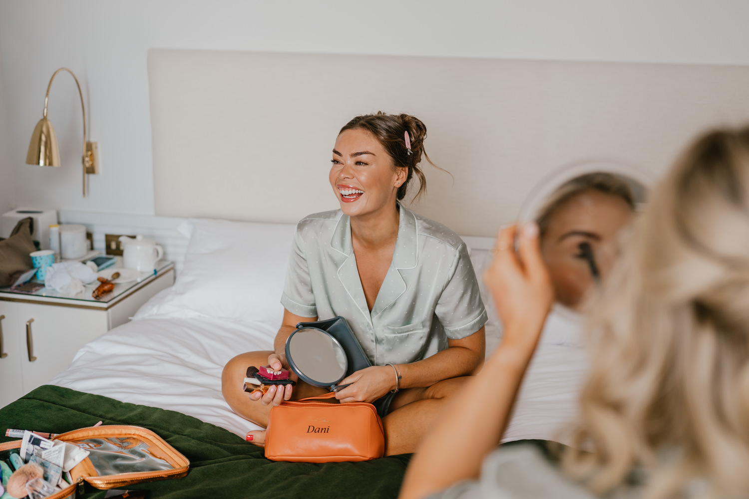 bridesmaid doing her makeup on wedding morning