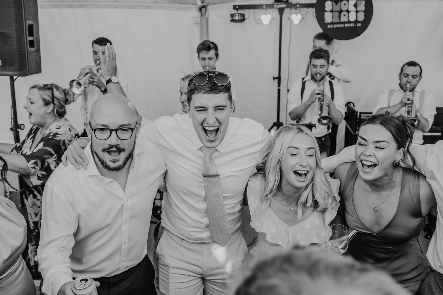 black and white image of guests partying on the dancefloor