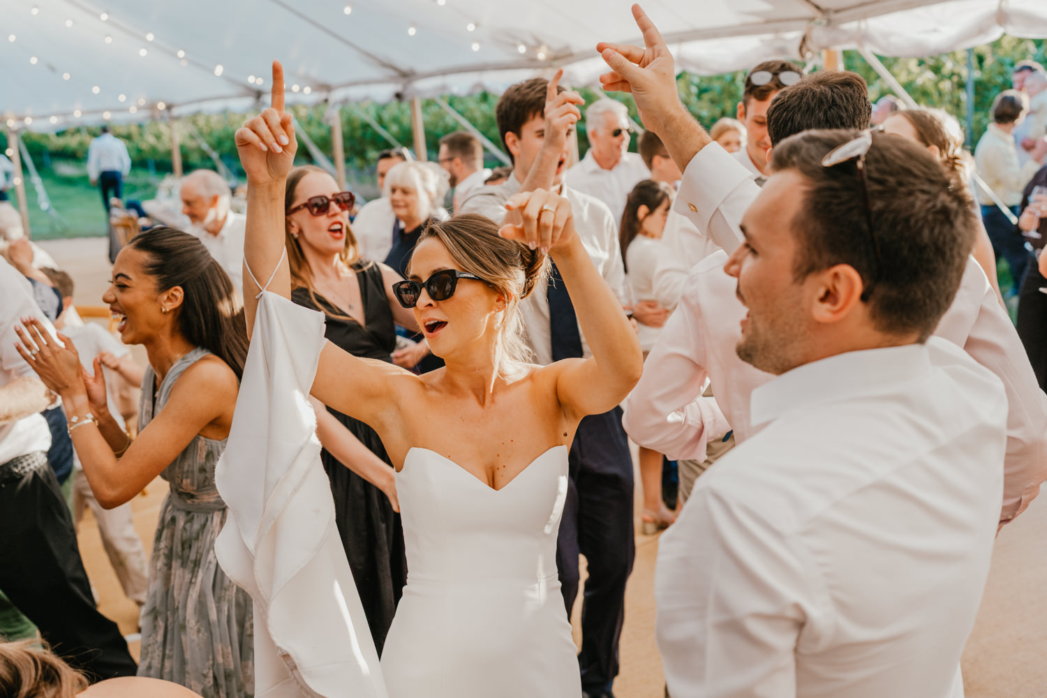 wedding guests on the dancefloor in the marquee at English Oak Vineyard wedding in Poole