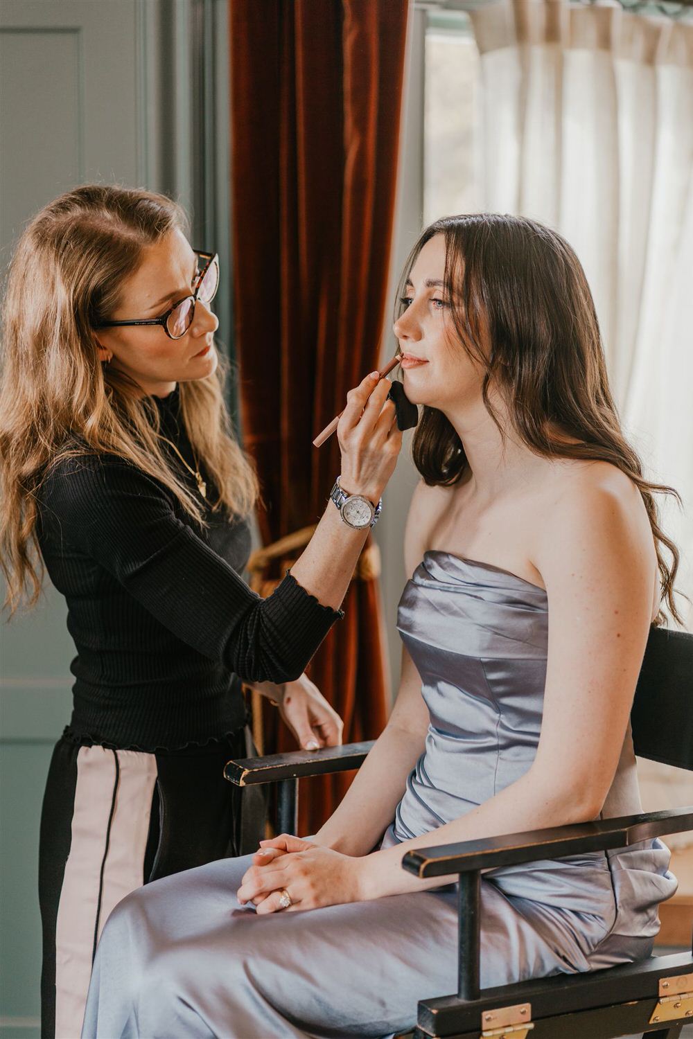 bridesmaid getting makeup done at the beacon tunbridge wells wedding