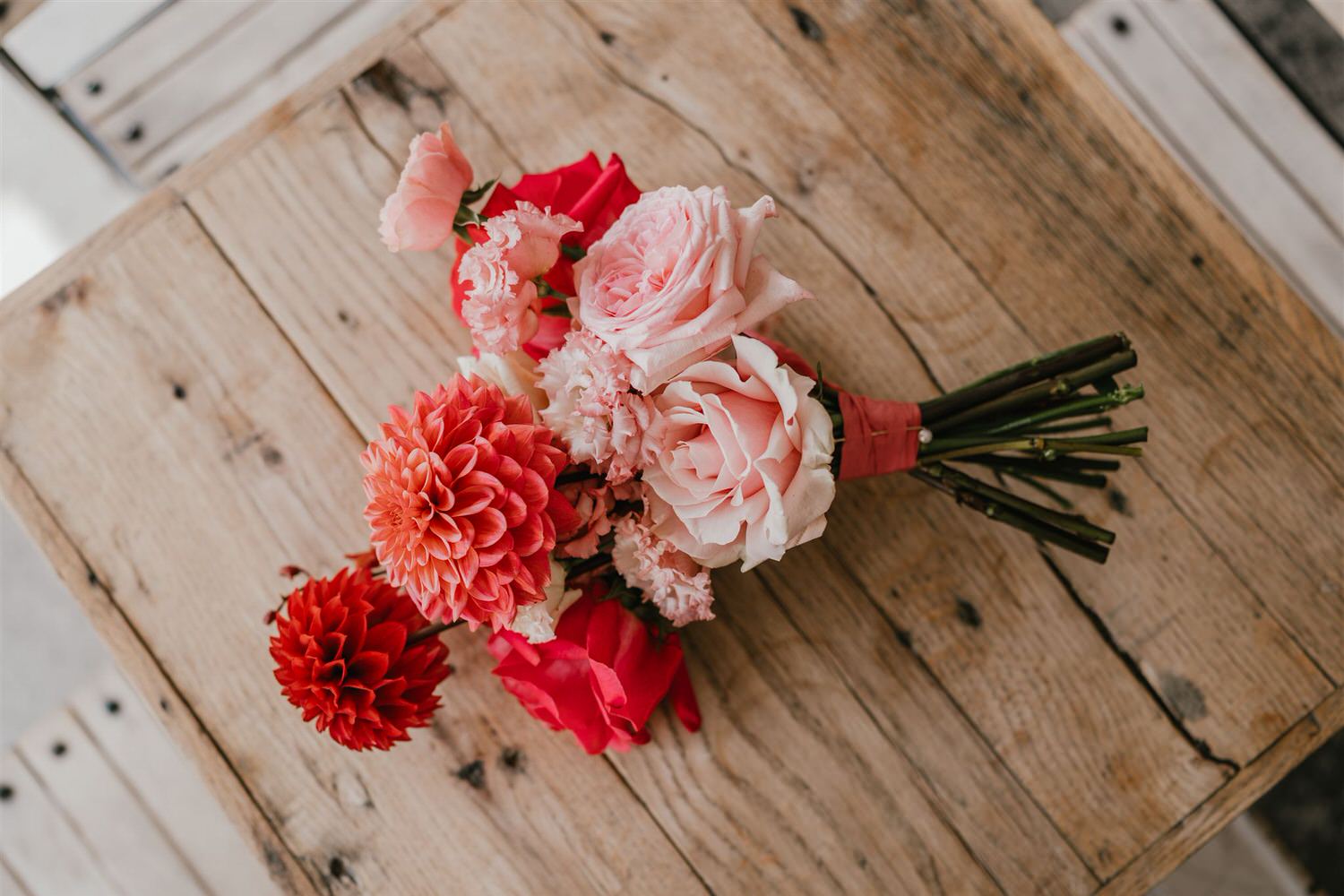 pink bridal bouquet on a wooden table at the beacon tunbridge wells wedding
