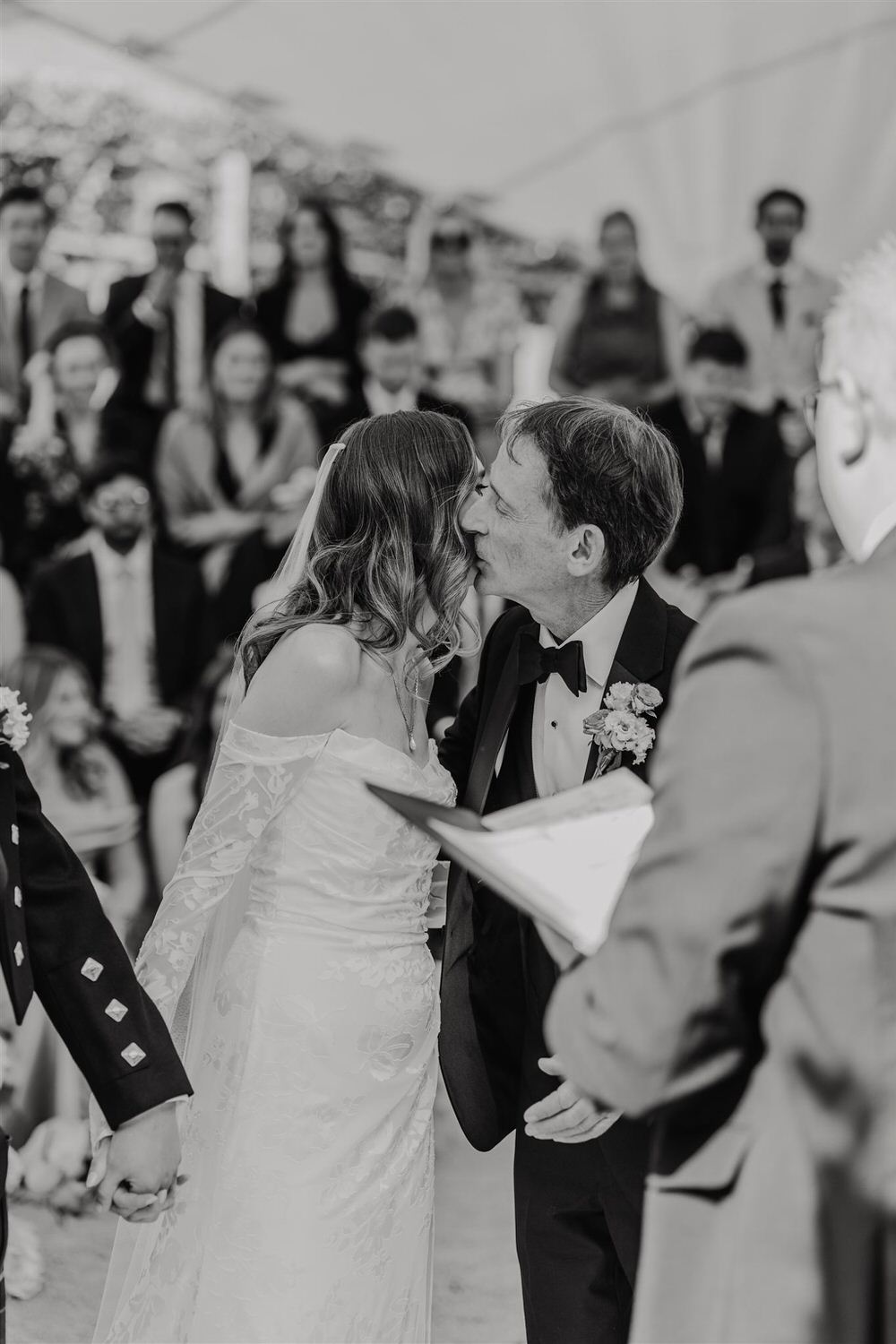 black and white photo of father of the bride kissing his daughter on the cheek at the beacon tunbridge wells wedding