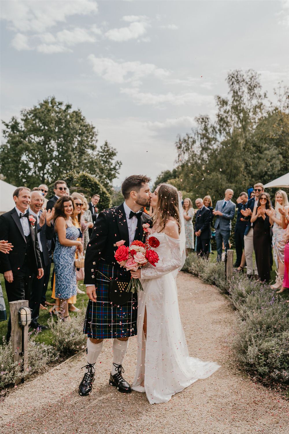 bride and groom kiss during confetti moment at the beacon tunbridge wells wedding