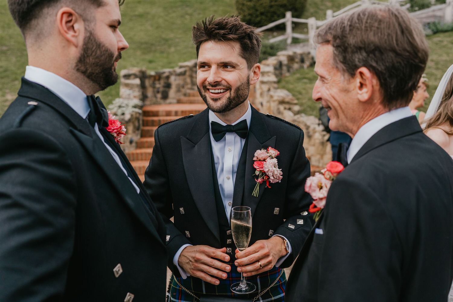 groom chats with groomsmen at the beacon tunbridge wells wedding drinks reception