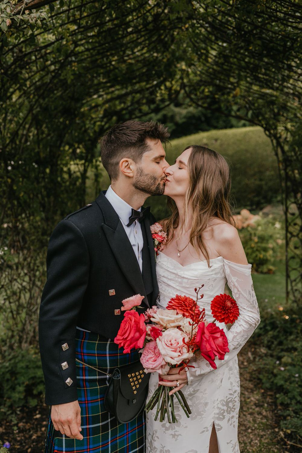 bride and groom kiss during couple portraits in the gardens at the beacon tunbridge wells wedding