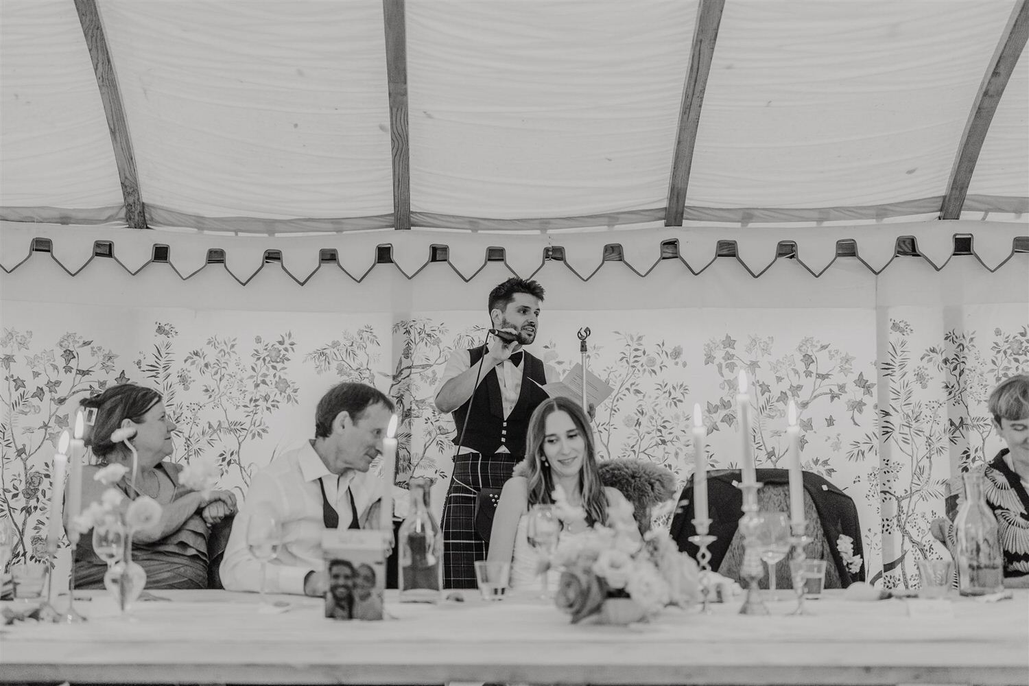 black and white photo of groom's speech in the bell tent at the beacon wedding venue in tunbridge wells