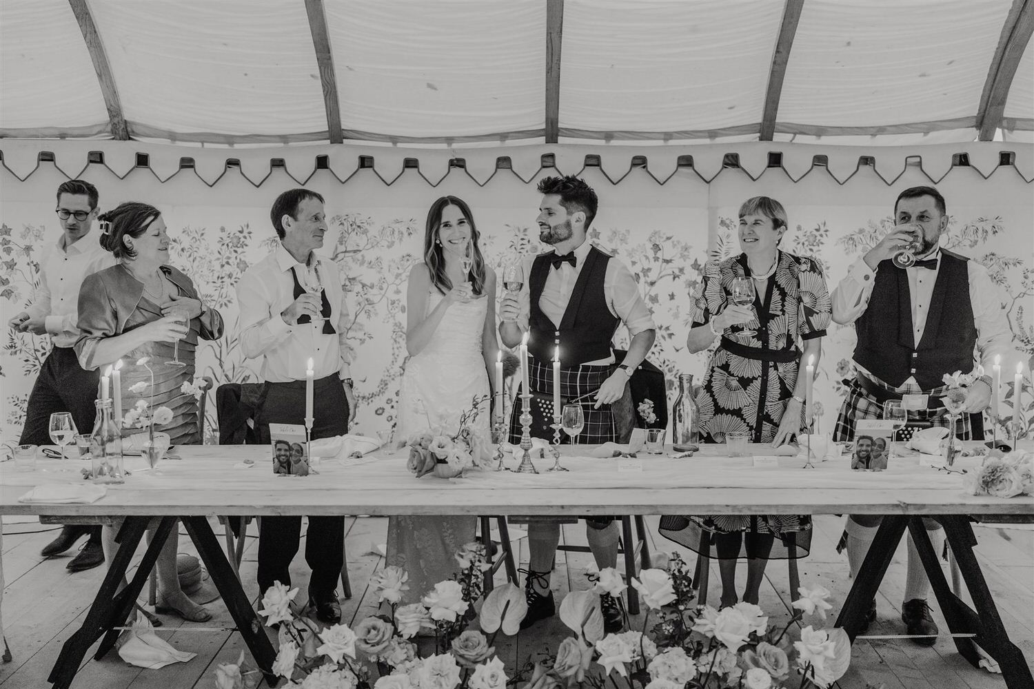 black and white photo of top table smiling after speeches at the beacon wedding