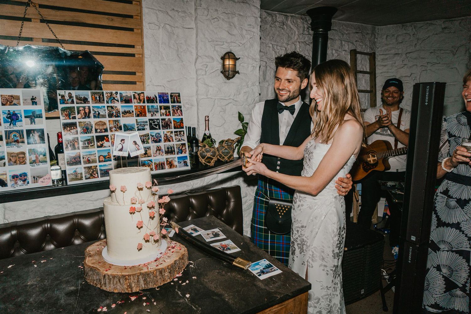 bride and groom cut cake with sword at the beacon wedding venue in tunbridge wells