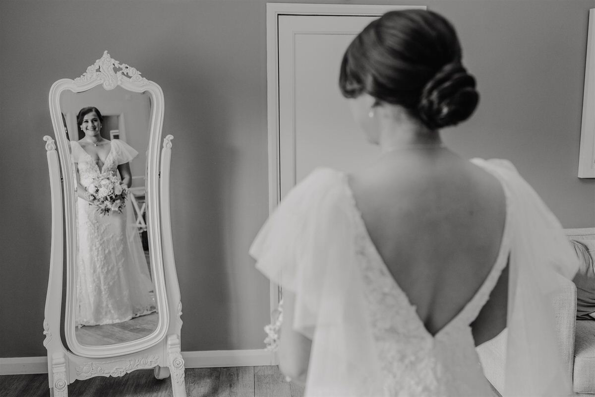 black and white image of bride reflected in a mirror