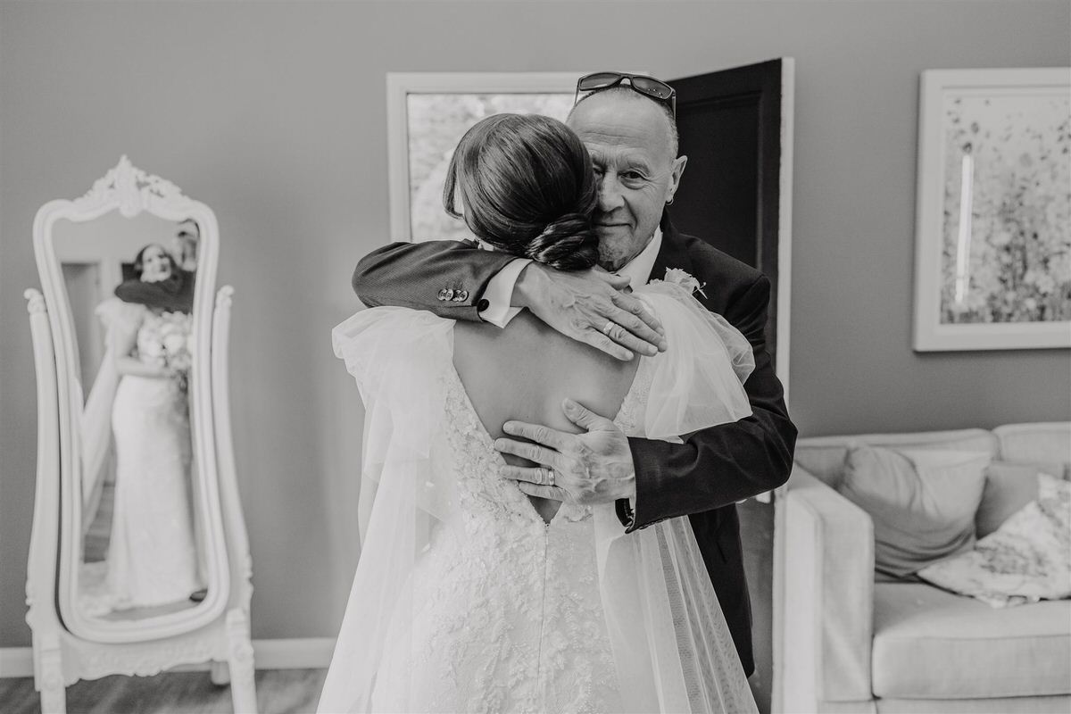 black and white image of bride's first look with her dad at winters barns in canterbury