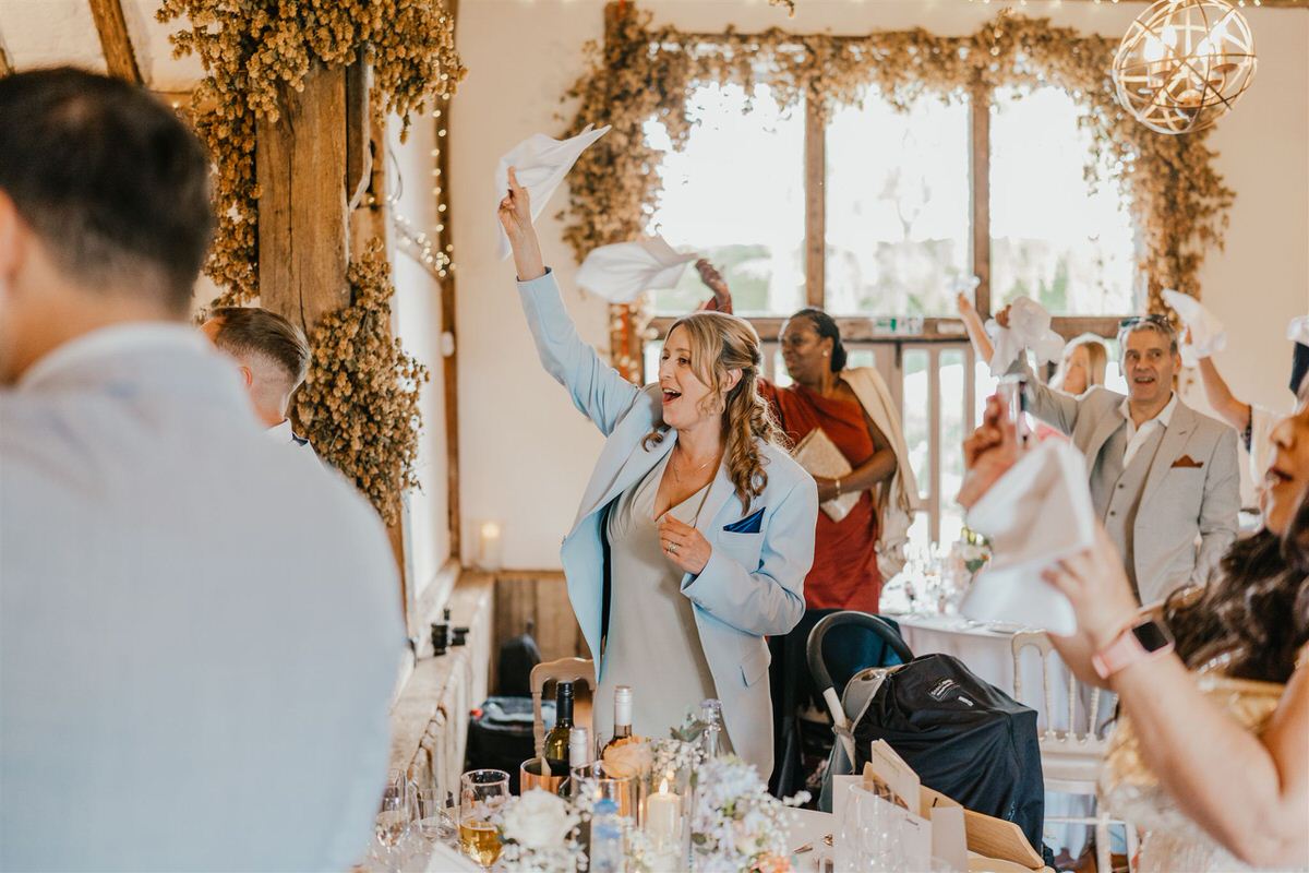 wedding guests welcome bride and groom into reception