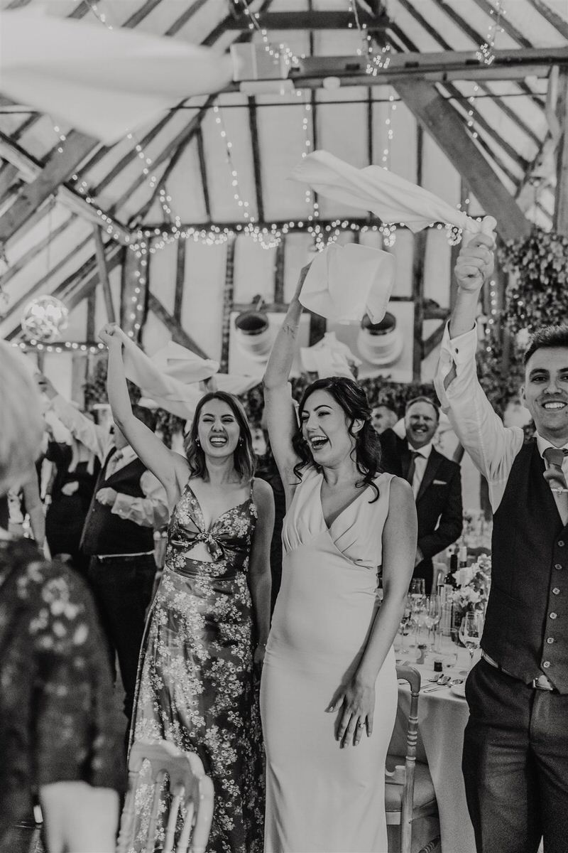 wedding guests welcome bride and groom into reception