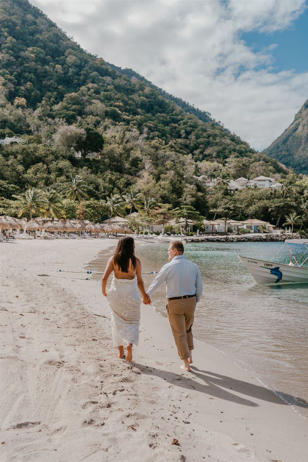 couple walking along sugar beach in saint lucia destination photography