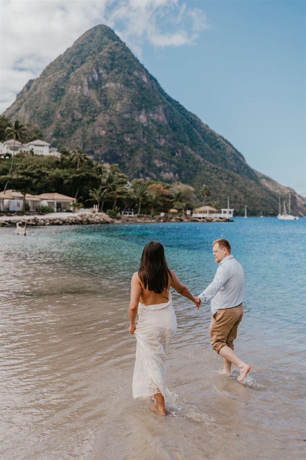 couple walking in the sea on sugar beach in saint lucia destination photography
