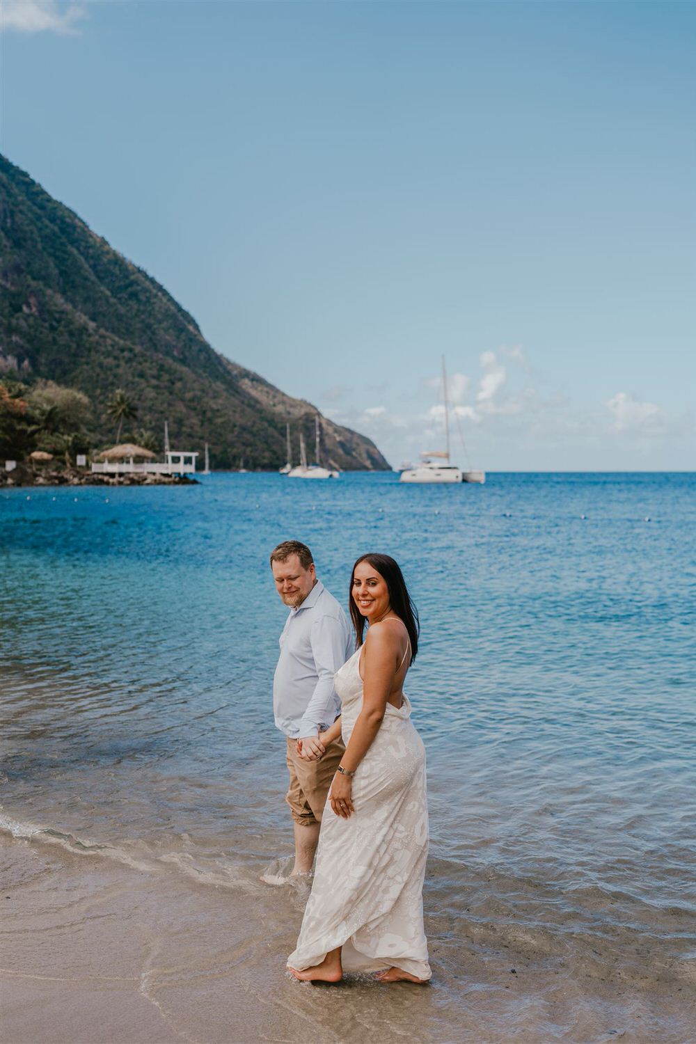 couple walking in the sea on sugar beach in saint lucia destination photography