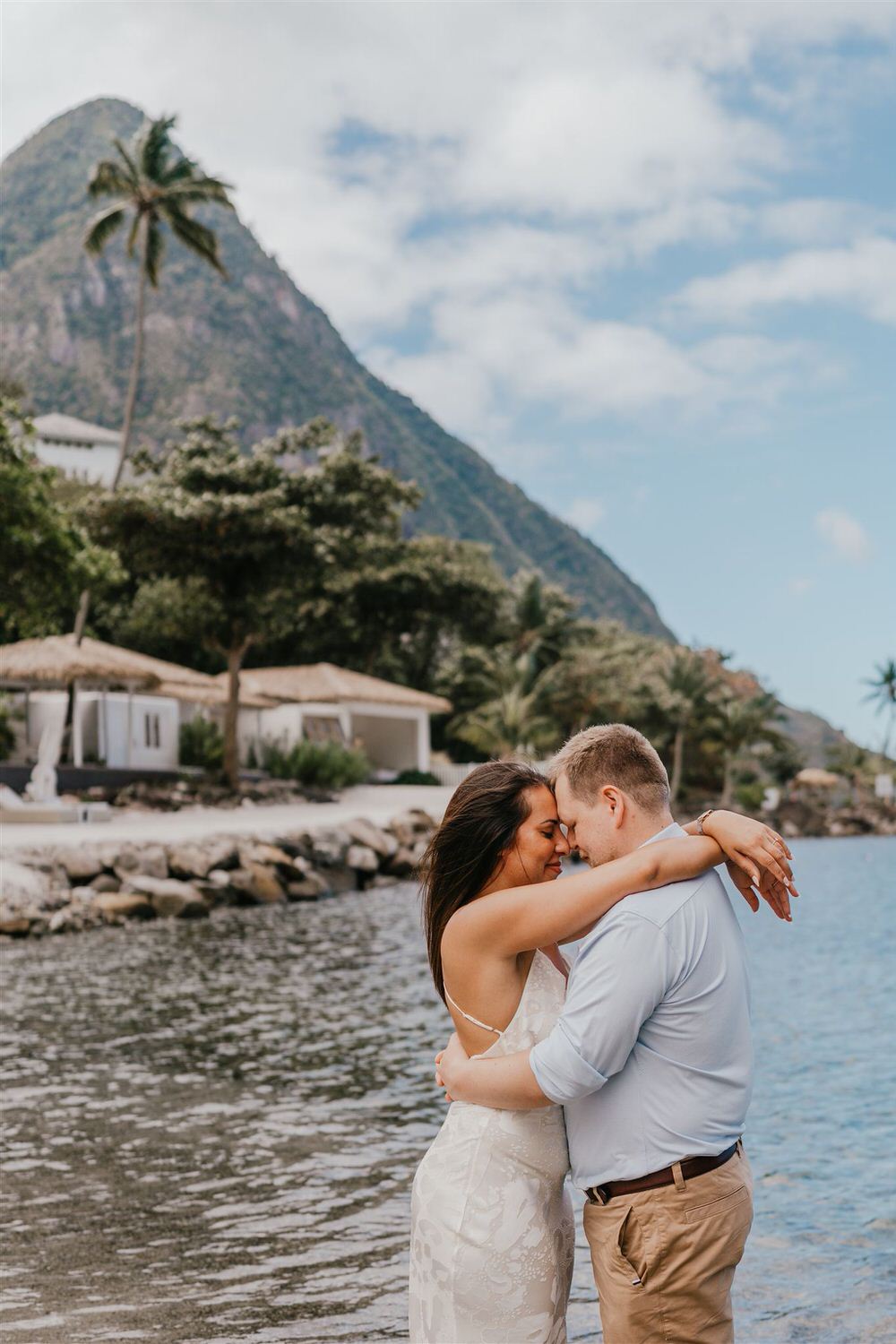 couple embracing on sugar beach in saint lucia destination photography