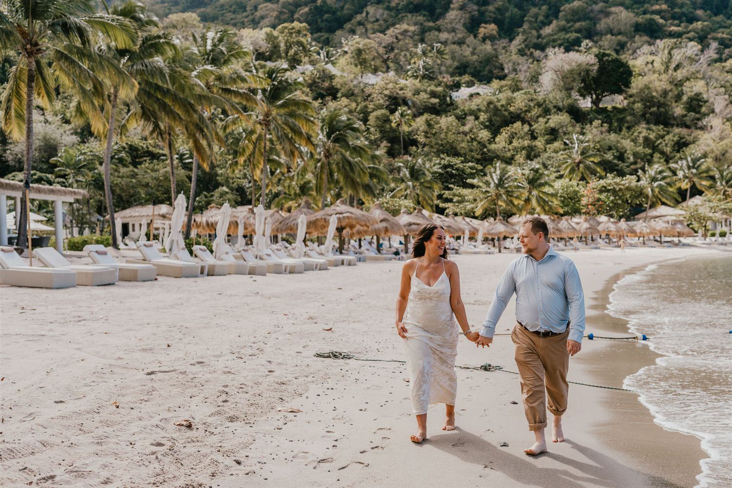 couple walking along sugar beach in saint lucia destination photography