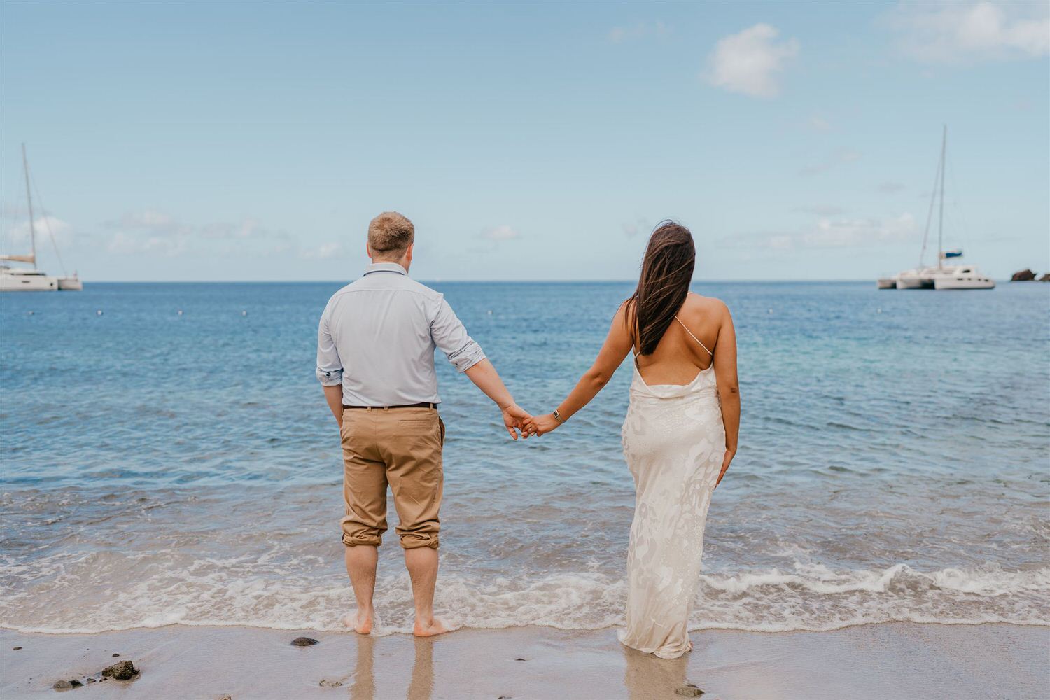 couple holding hands on sugar beach in saint lucia destination photography