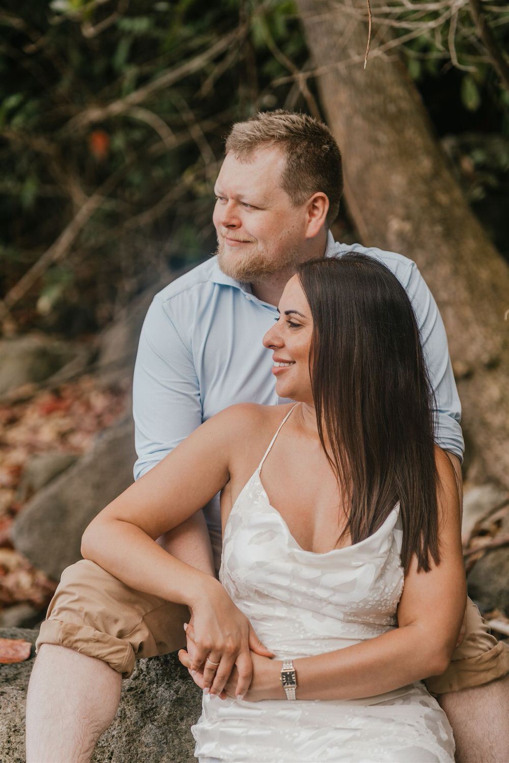 couple sitting on rocks on sugar beach in saint lucia destination photography