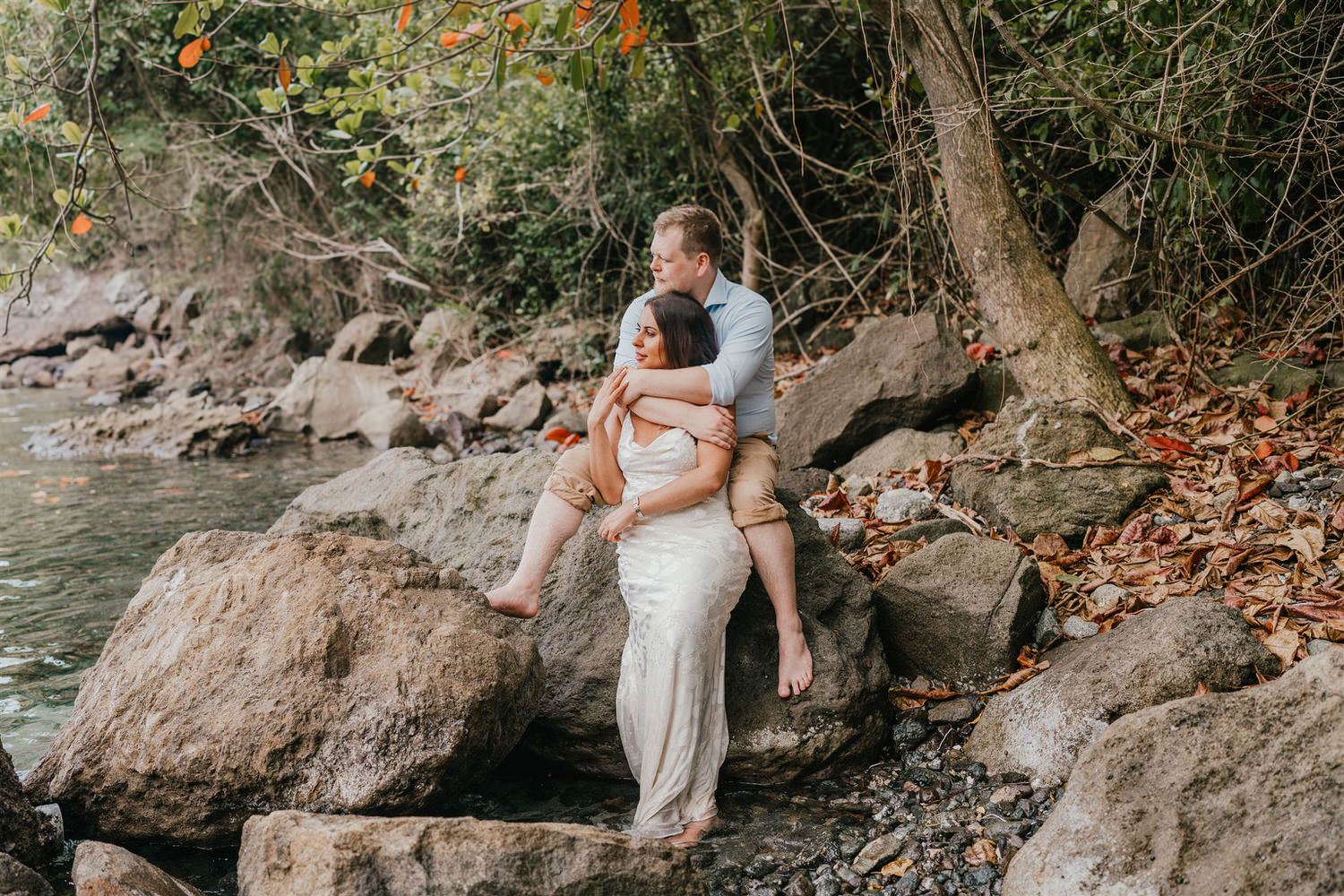couple sitting on rocks on sugar beach in saint lucia destination photography