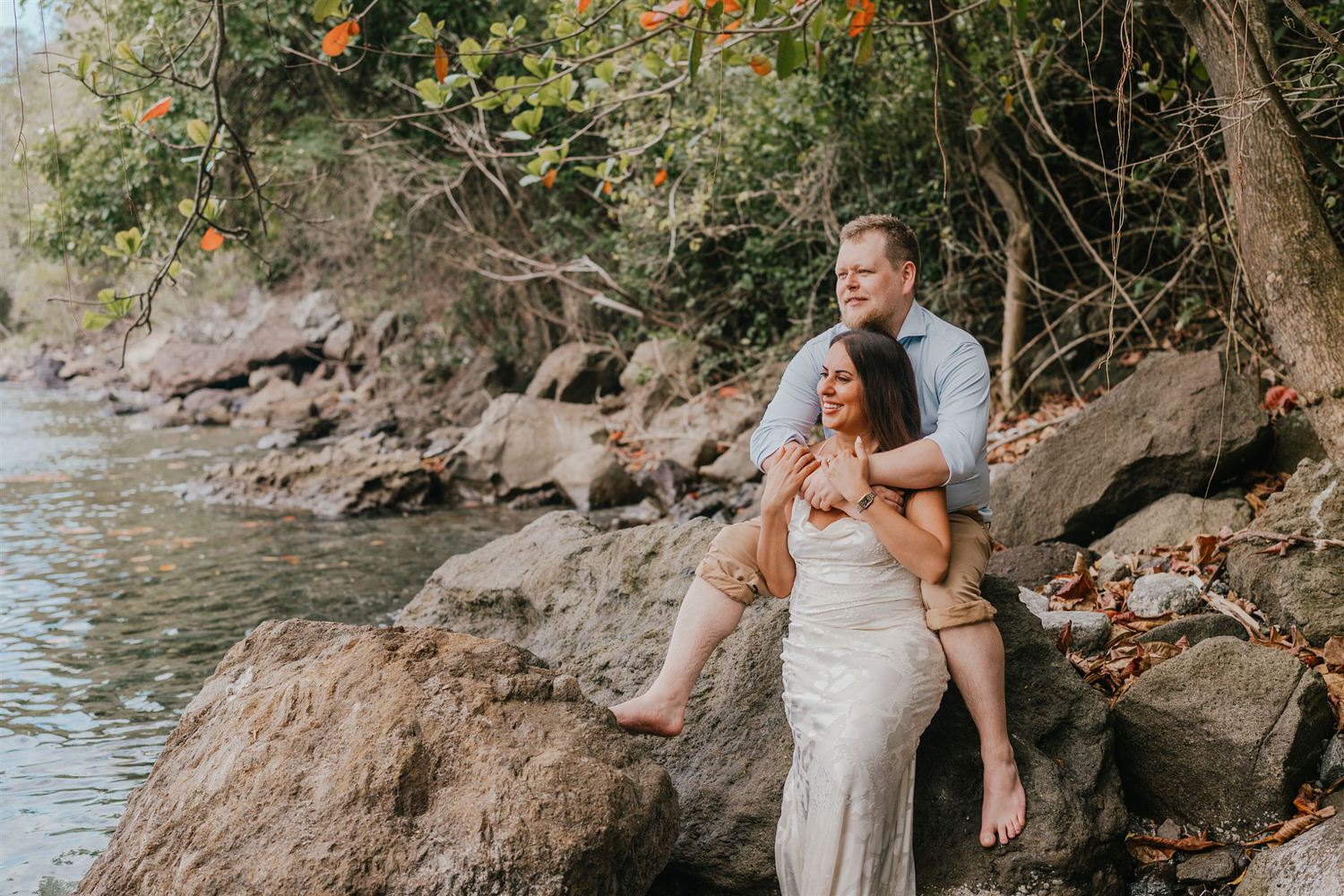 couple sitting on rocks on sugar beach in saint lucia destination photography