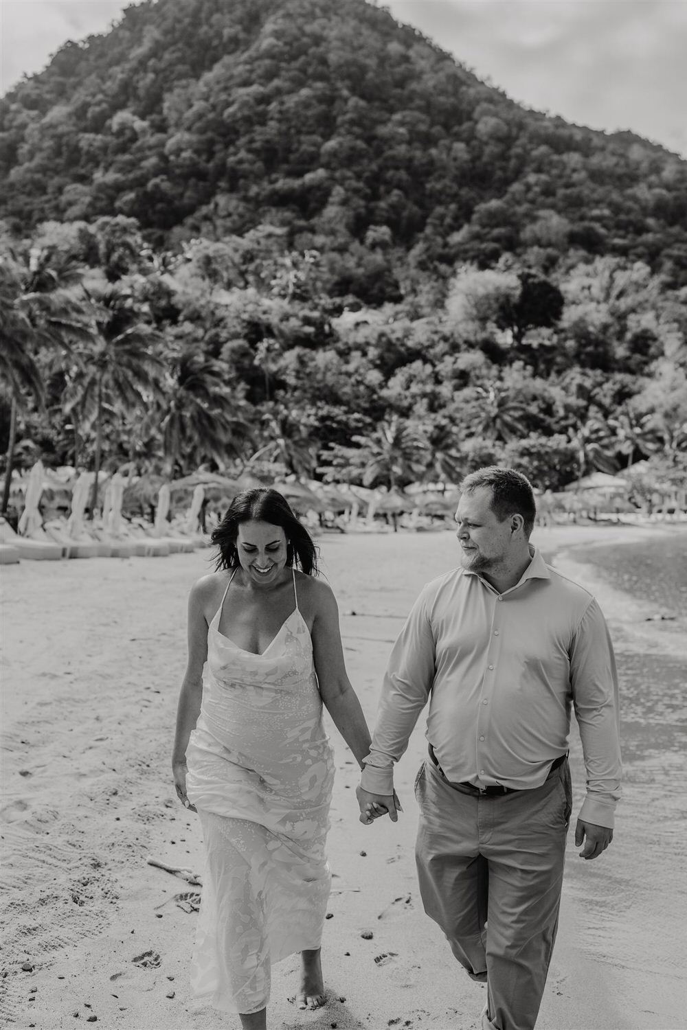 black and white image of couple walking along sugar beach in saint lucia destination photography