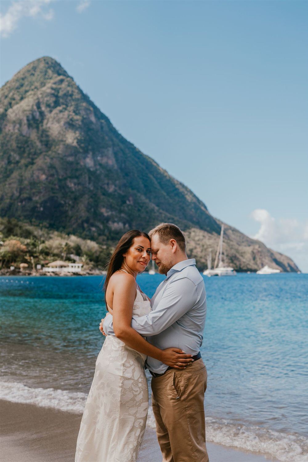 couple embracing on sugar beach in saint lucia destination photography