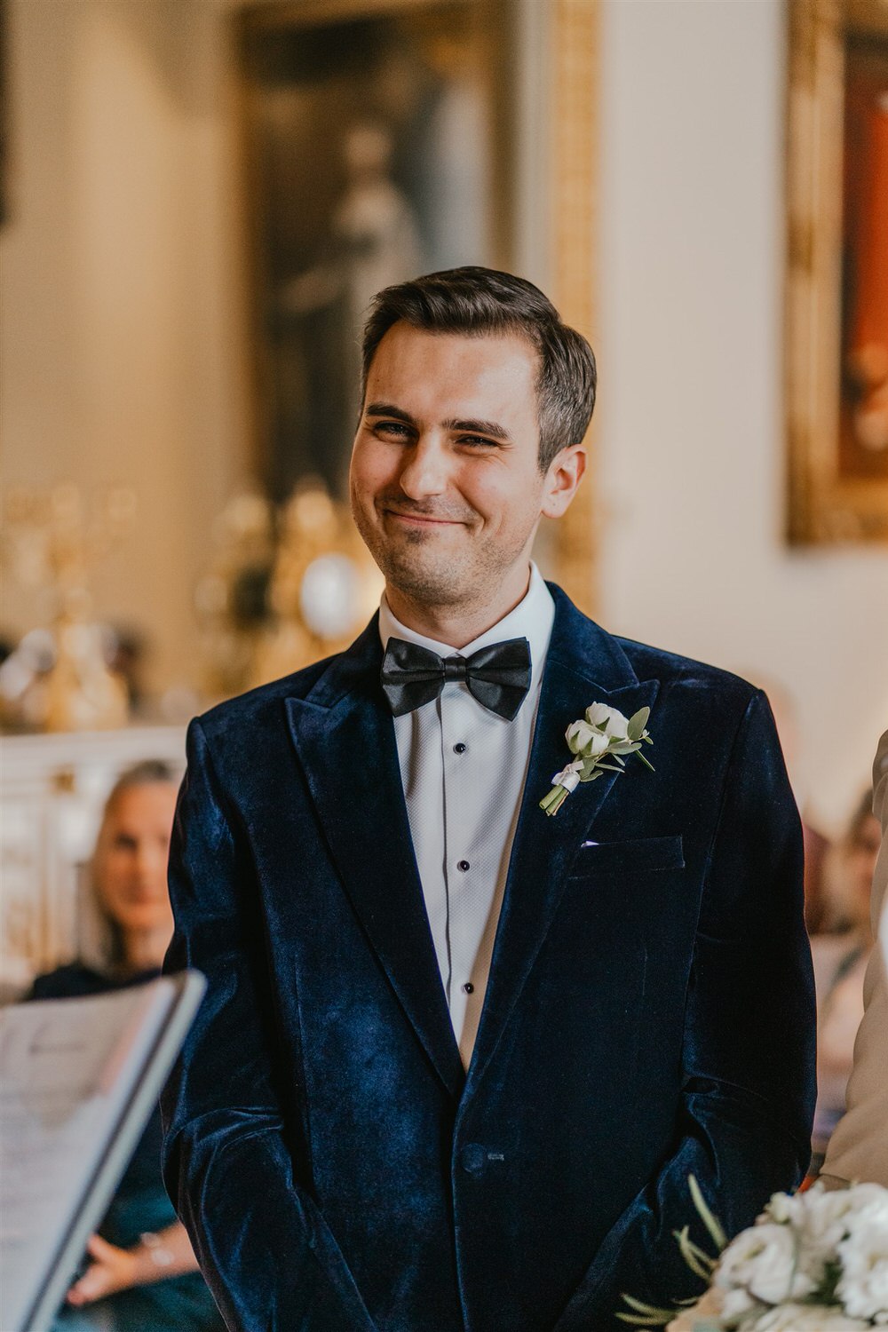 groom smiles at trinity house wedding ceremony
