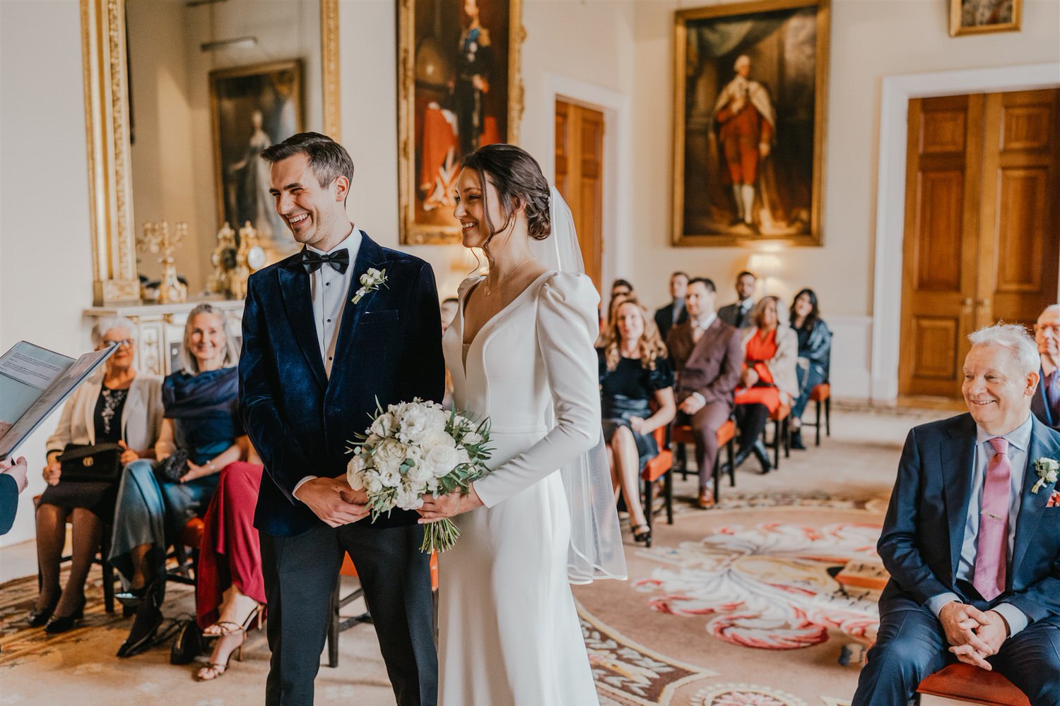 bride and groom laugh during ceremony at trinity house winter wedding in london