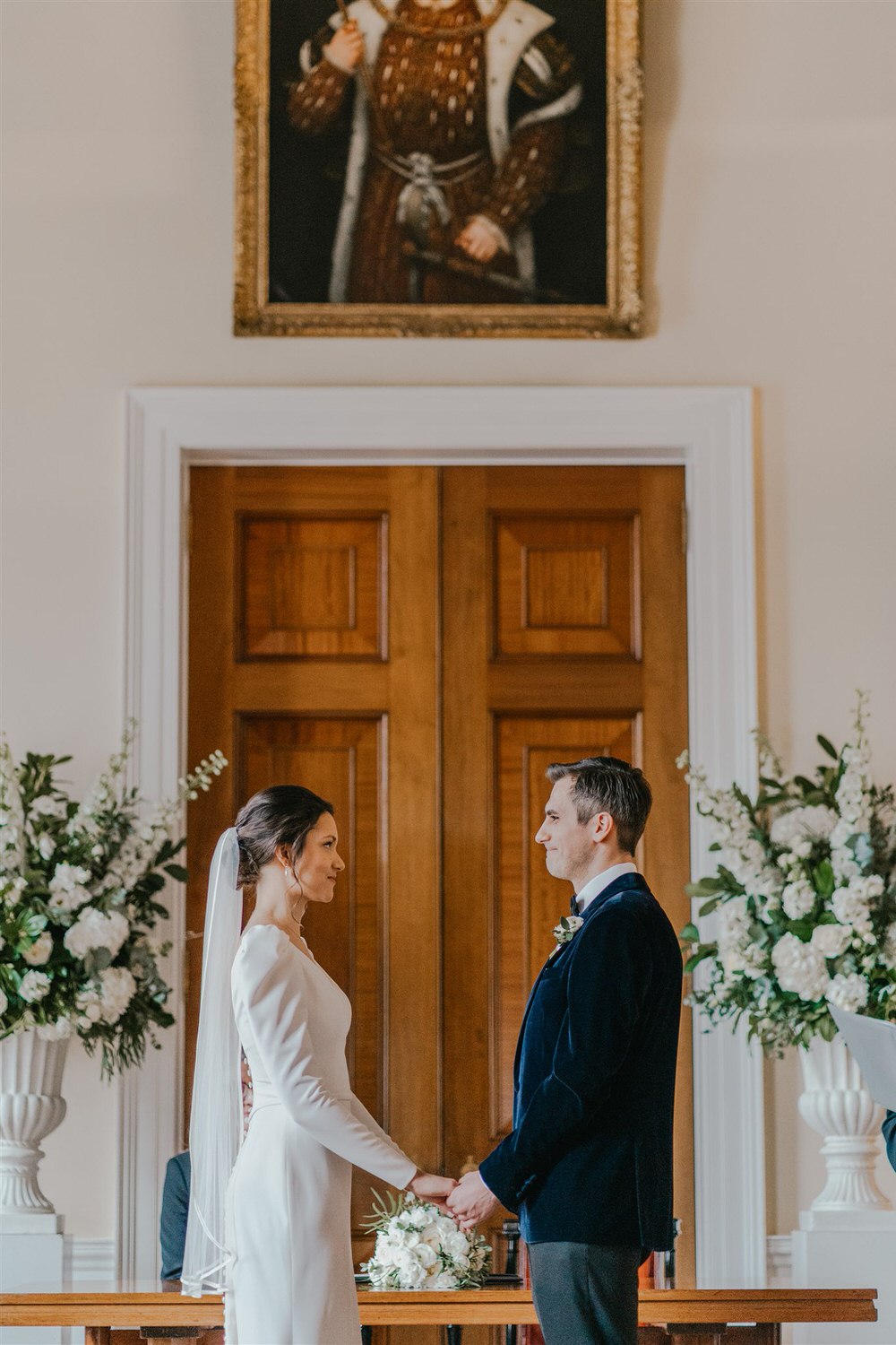 bride and groom say their vows at trinity house winter wedding in london