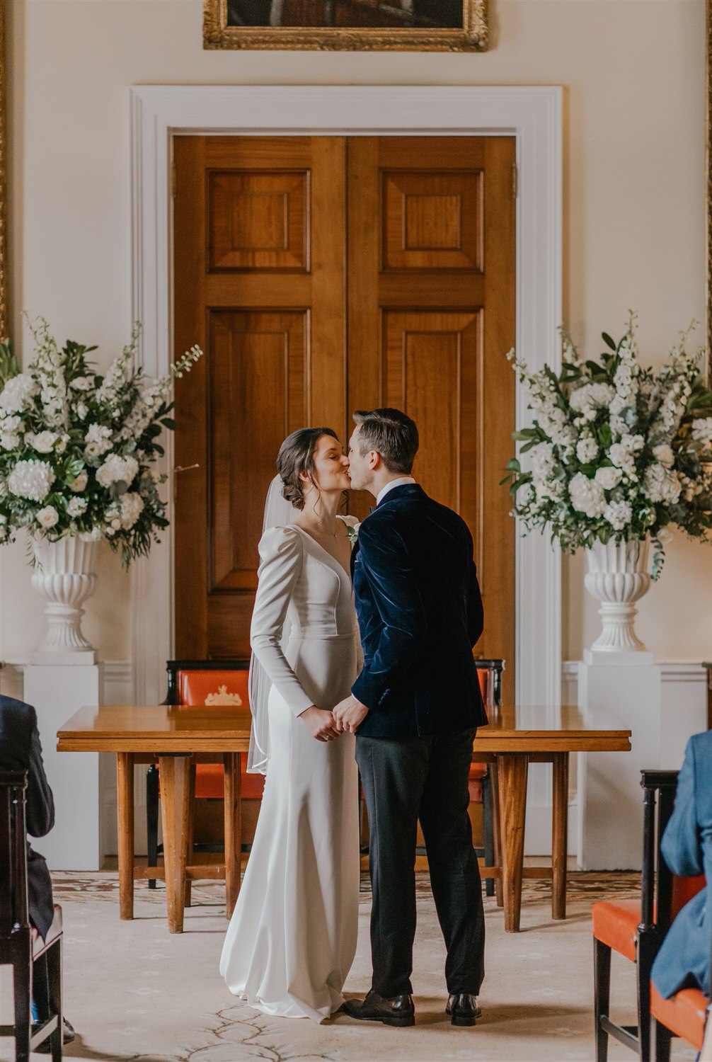 bride and groom first kiss at trinity house winter wedding in london