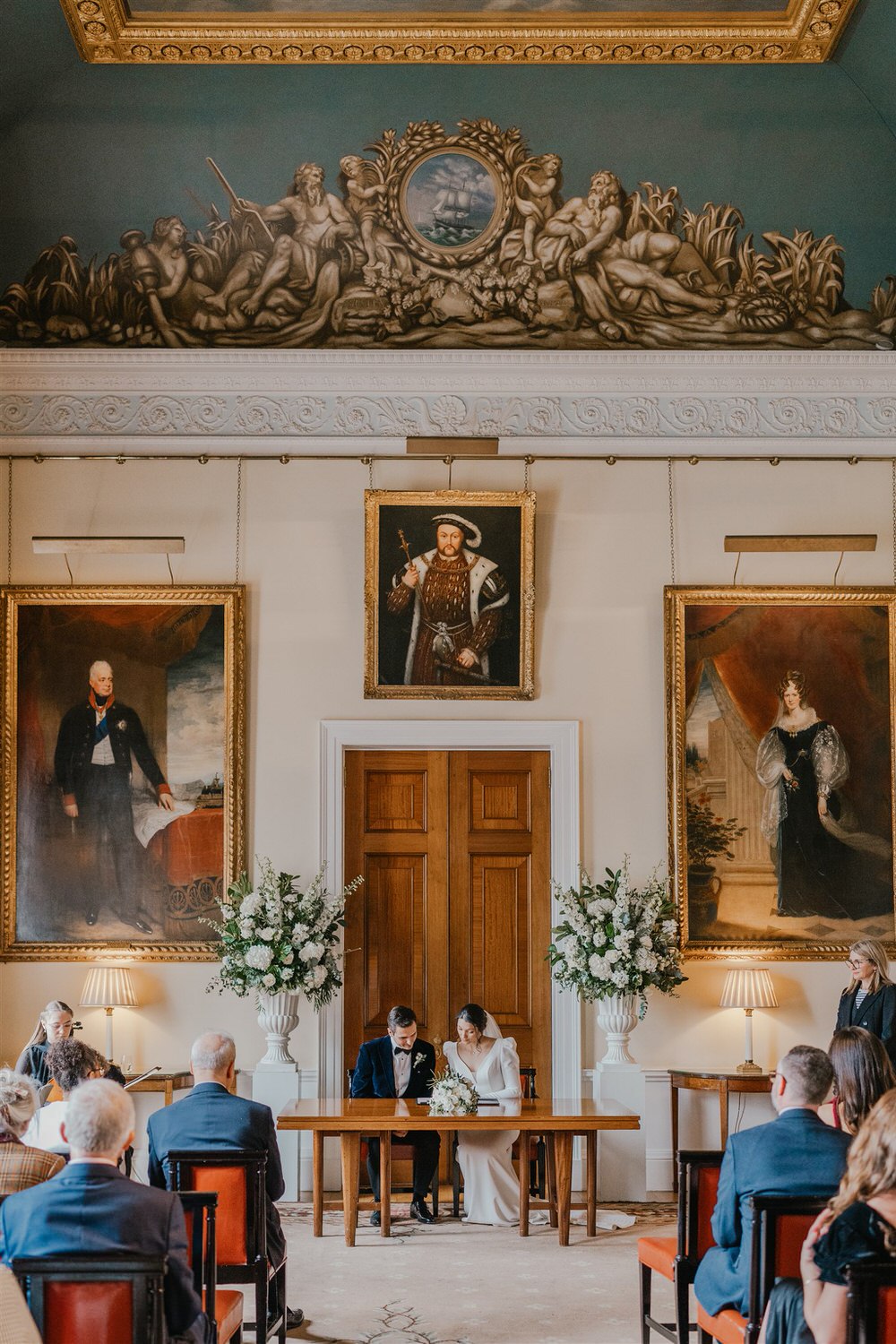bride and groom sign wedding register at trinity house winter wedding in london