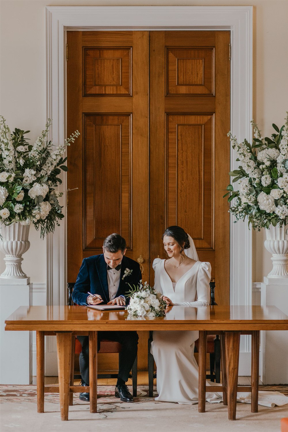 bride and groom sign register at trinity house winter wedding in london