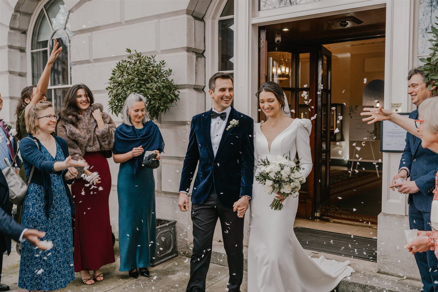 confetti tunnel outside trinity house winter wedding in london