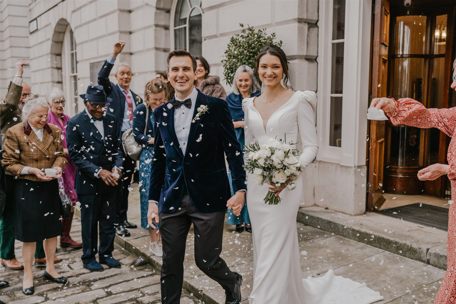 confetti tunnel outside trinity house in london winter wedding