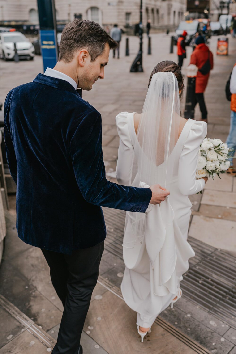 bride and groom walking at winter wedding in london
