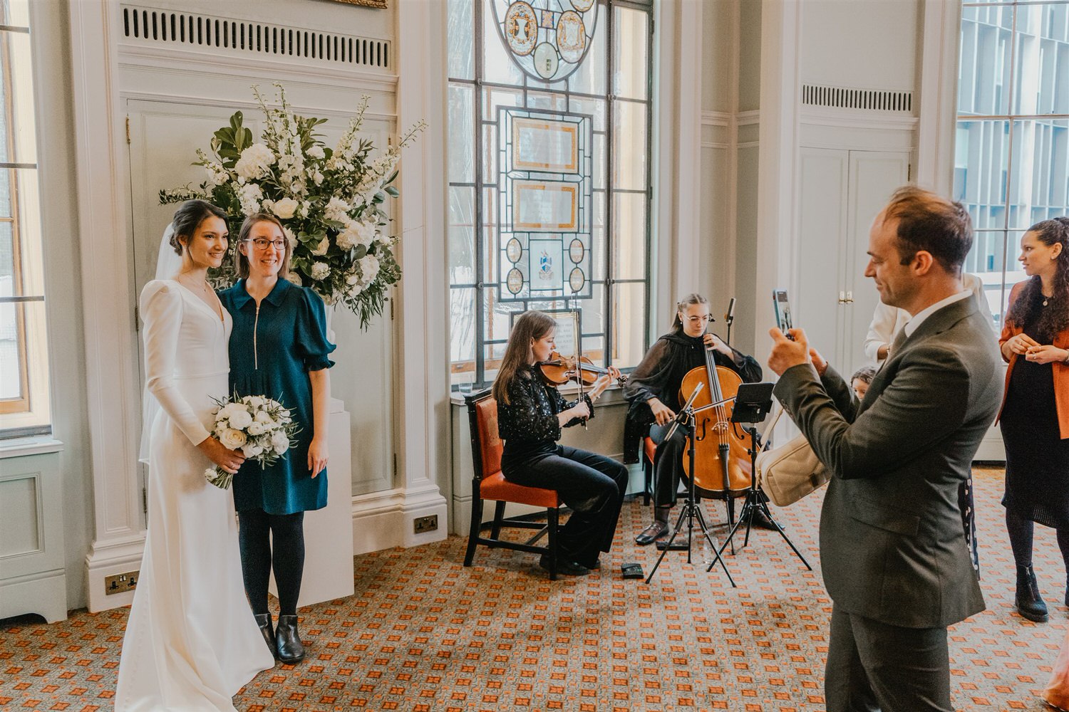 guest candids during drinks reception in the library at trinity house in london