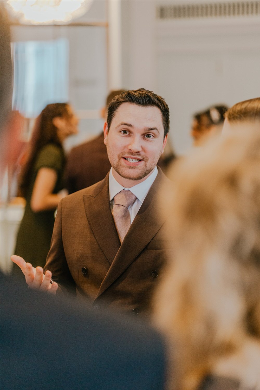 guest candids during drinks reception in the library at trinity house in london