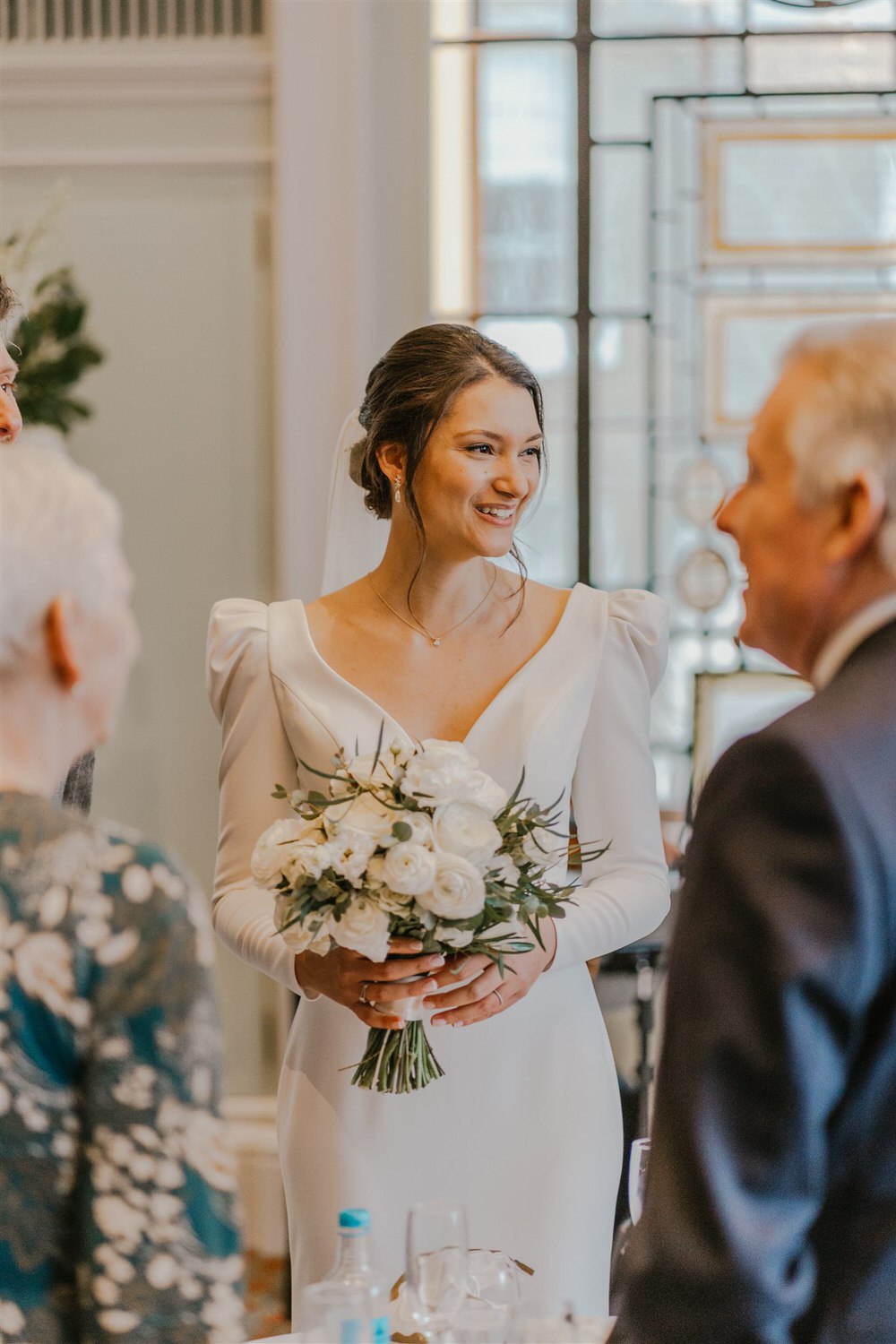 bride candids during drinks reception in the library at trinity house in london