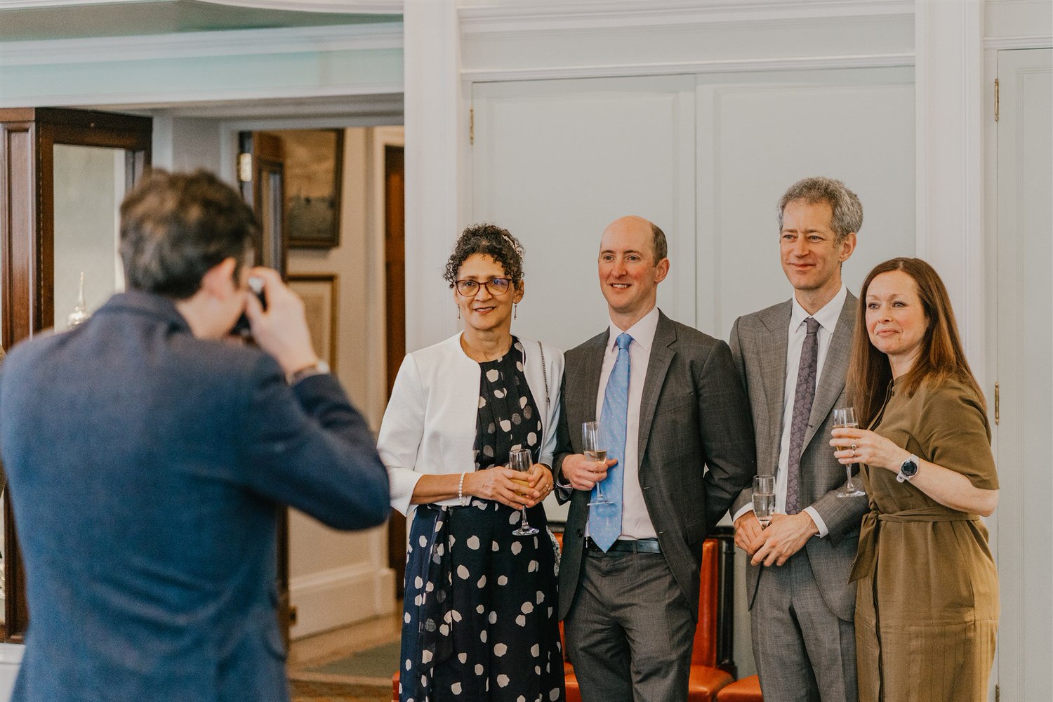 guest candids during drinks reception in the library at trinity house in london