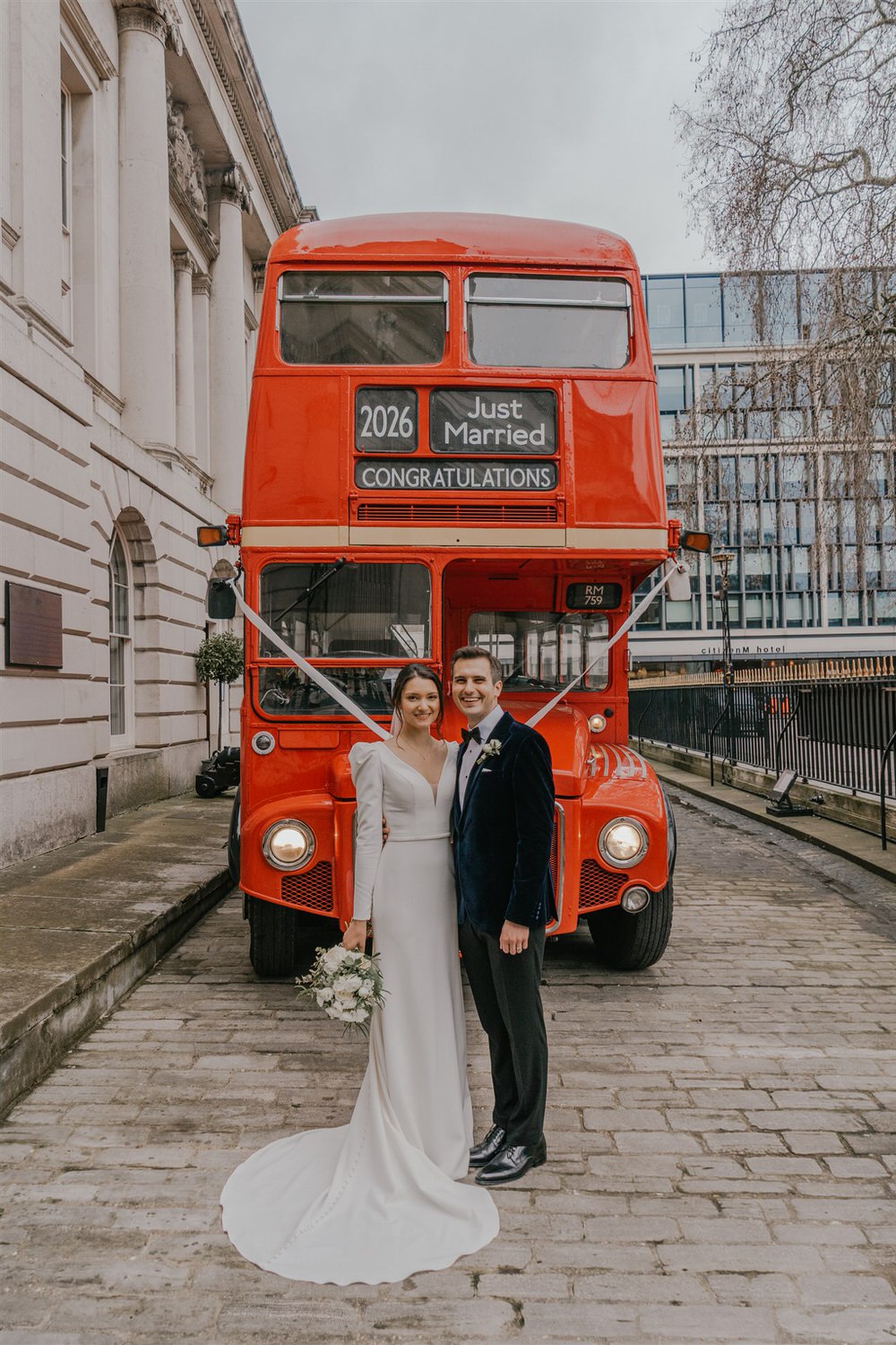 bride and groom with routemaster bus outside trinity house london