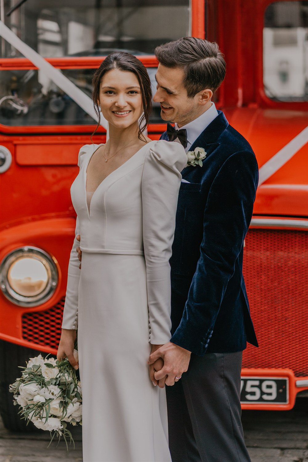 bride and groom with routemaster bus outside trinity house london