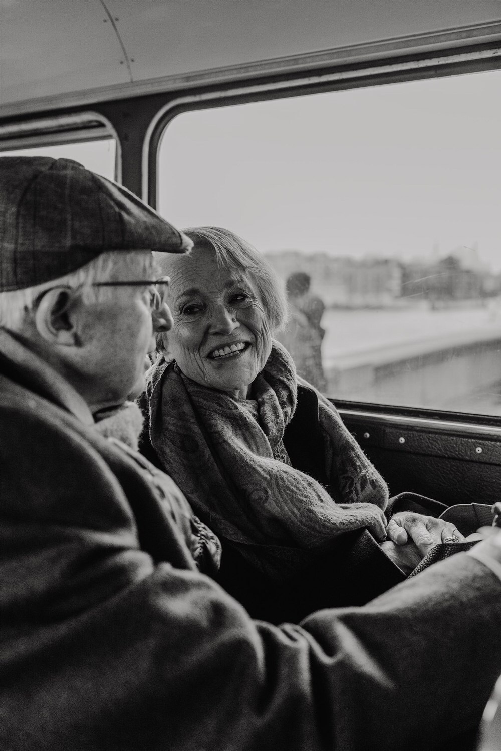 black and white photo of wedding guests on routemaster bus at winter wedding in london tower bridge