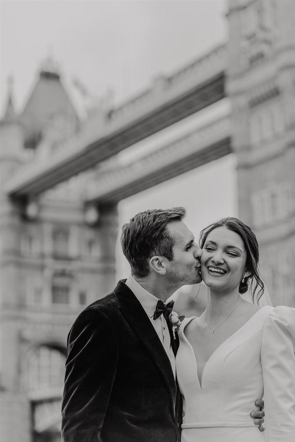 black and white bride and groom couple portraits with tower bridge in london winter wedding