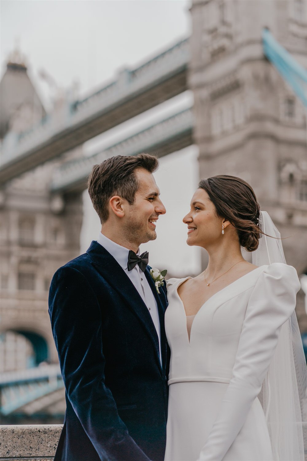 bride and groom couple portraits with tower bridge in london winter wedding