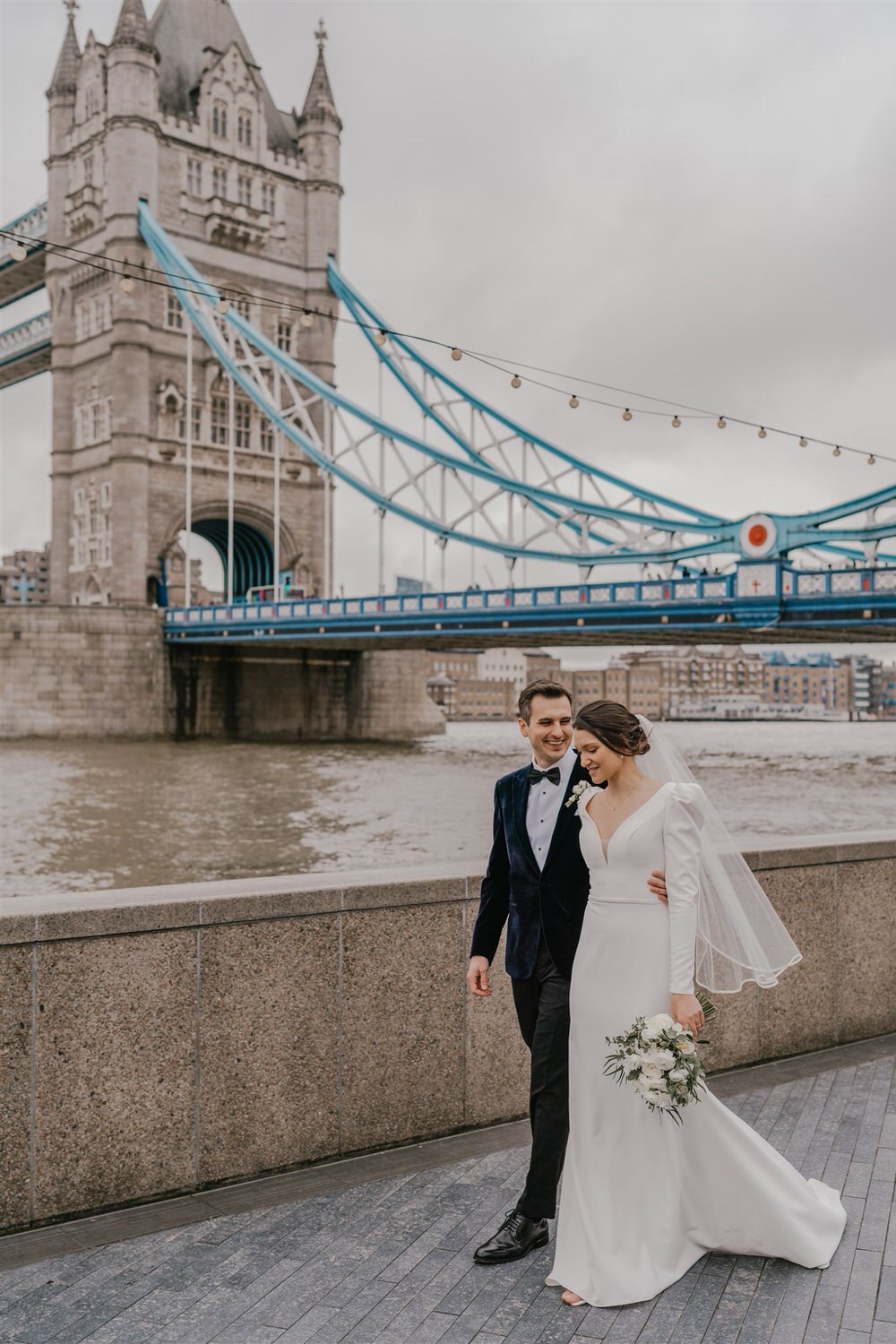 bride and groom couple portraits with tower bridge in london winter wedding